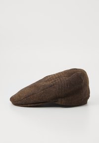 Brown wool flat cap with a rounded crown, curved peak, and subtle texture. Features a classic design with seamless stitching.