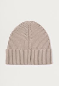 Knit beanie in light beige with a ribbed cuff and subtle cable patterns, featuring a smooth, textured finish.