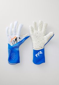 Goalkeeper gloves with a blue textile body and grip patterns. White palms with black speckles, featuring branding on the thumb and wrist.