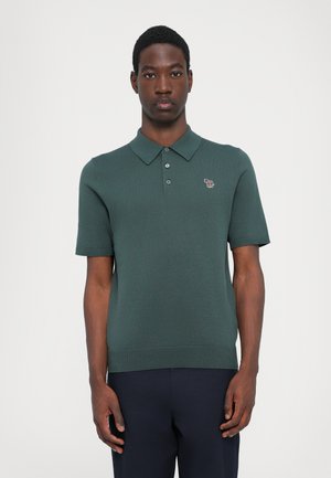 Knitted short-sleeve polo shirt in dark green. Features a collared neck, three-button placket, and a small embroidered animal logo on the chest.