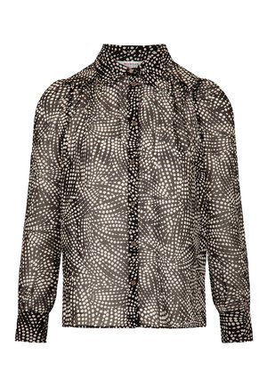 Blouse à pois noir et blanc avec col haut, fermeture par boutons et manches bouffantes. Fabriquée en tissu léger et transparent.