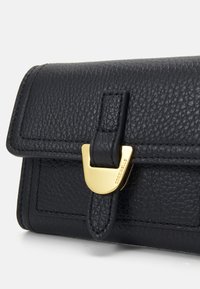 Black leather wallet with a textured finish, featuring a gold-tone clasp and a rectangular shape. Includes branding detail on the hardware.