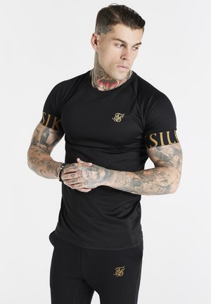 DYNAMIC TECH TEE - Triko s potiskem - black/gold