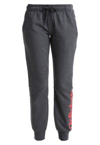 Grijze sweatpants met een elastische tailleband, trekkoord en zijzakken. Kenmerkt zich door een verticale rode logoprint langs het linkerbeen. Zacht materiaal.