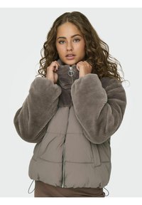 Faux fur puffer jacket in shades of brown, featuring a high collar, voluminous sleeves, and zippered front with a silver pull.