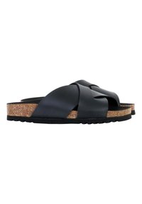 Sorte krydsrem-sandaler med en tekstureret kork-skok og gummisål. Remmene er matte, mens skokket har en naturlig finish.