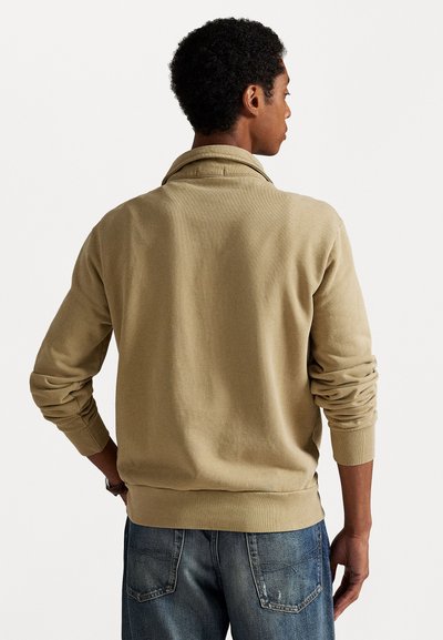 Beige katoenen trui met een kraag, lange mouwen en ribgebreide manchetten. Met een relaxte pasvorm en een subtiele textuur op de stof.