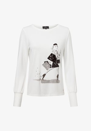 White long-sleeve shirt with a black graphic print of a stylish figure. Features a round neckline and gathered cuffs. Soft, textured fabric.