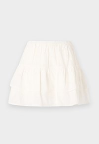 White tiered skirt made of cotton with eyelet embroidery, featuring an elastic waistband and a lightweight, textured fabric.