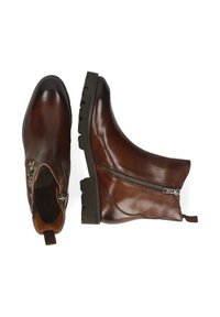 Botines de cuero marrón con cremallera lateral, puntera redondeada, suela texturizada y una lengüeta para tirar en el talón. Acabado suave con un brillo sutil.