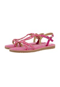 Sandalias rosas con tiras trenzadas, decoradas con pequeños adornos. Plantilla de un suave tono rosa y suela de goma marrón claro. Correa ajustable para el tobillo.