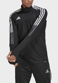 Schwarzes, langärmliges Sportoberteil mit hohem Kragen, das weiße drei gestreifte Akzente an den Ärmel und ein "AEROREADY"-Label in der Nähe des Saums aufweist.