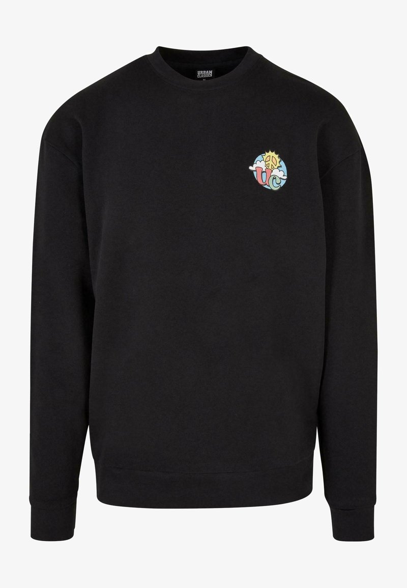 Sweat-shirt noir à manches longues avec un petit logo coloré de soleil et de signe de paix, et les lettres "UC" sur la poitrine gauche. Aucun mannequin visible.
