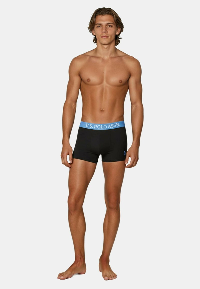 Black boxer briefs with a light blue elastic waistband, featuring the text "U.S. POLO ASSN." in a bold font. Smooth fabric texture.