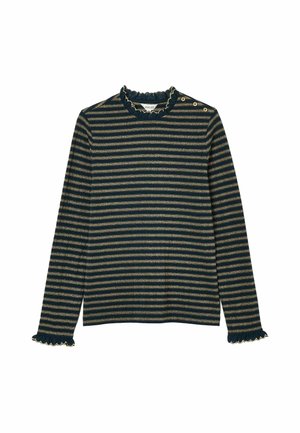 Schwarze Cordjacke, gestreiftes grün-gelbes Oberteil, beiger langer Rock, weiße Socken und goldene Mary Jane Schuhe mit seitlichem Knopfdetail.