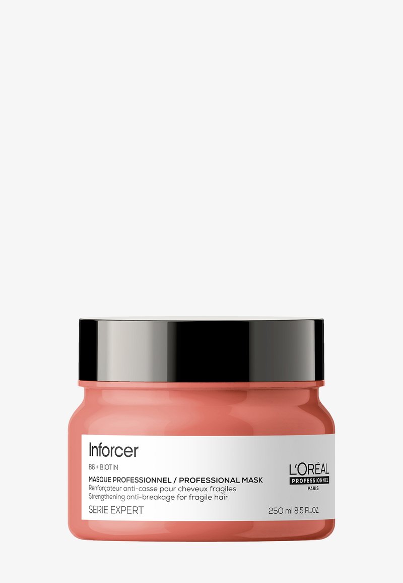 L'Oréal Inforcer professional hair mask in a pink plastic jar with a black lid. Label features white and black text, indicating product details.