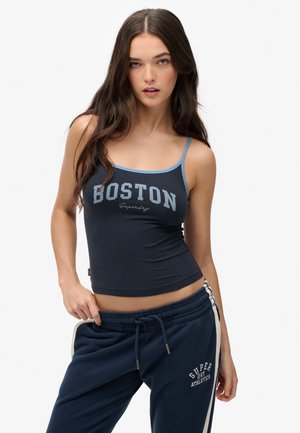 Navy tank top with light blue straps and "BOSTON" text printed in gray. Pair of matching navy sweatpants with white side stripes and logo.