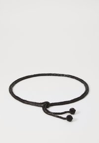 Black woven belt made of textured material, featuring a knot design and two round, beaded ends. Circular accents are prominent details.