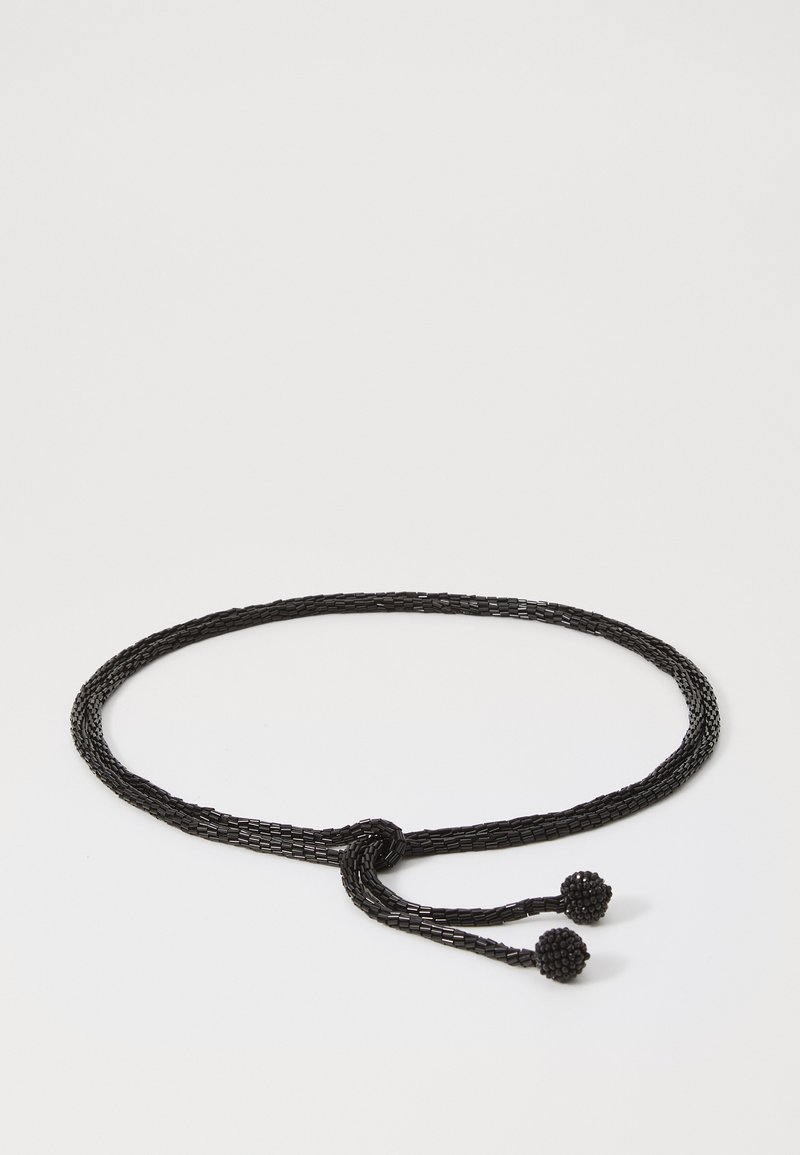 Black woven belt made of textured material, featuring a knot design and two round, beaded ends. Circular accents are prominent details.