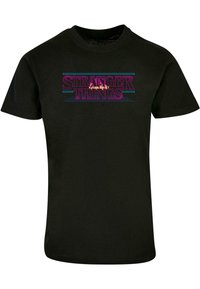 Black cotton t-shirt featuring the text "STRANGER THINGS" in purple and blue with a retro design, short sleeves, and a crew neckline.