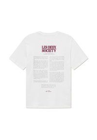 White cotton t-shirt featuring a large text print on the back in burgundy. Text explains the brand and philosophy with a standard crew neck design.
