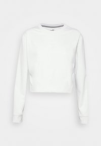 Biała, krótka bluza z długim rękawem, okrągłym dekoltem i gładką dzianiną. Posiada subtelną detal szwu na przodzie.