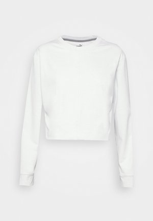 Vit kortärmad sweatshirt med lång ärm, rund halsringning och en slät stickad textur. Har en subtil sömdetalj på framsidan.