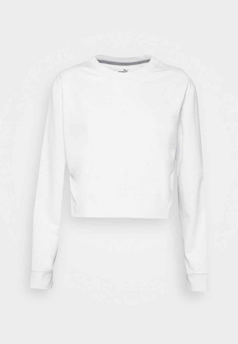 Bílé zkrácené teplákové triko s dlouhými rukávy, kulatým výstřihem a hladkým pleteným materiálem. Obsahuje jemný ševový detail na přední straně.