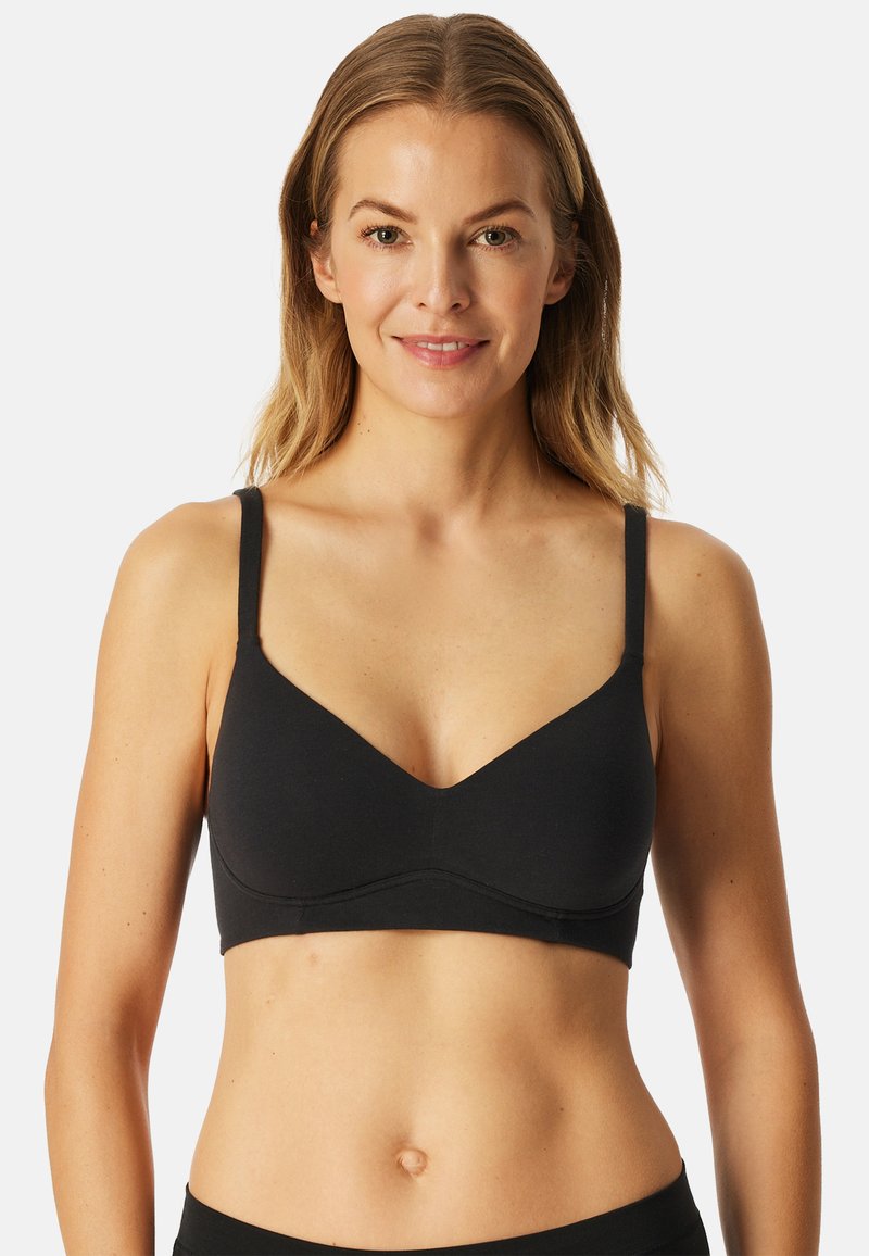 Reggiseno nero con texture liscia, design a V, spalline sottili e regolabili, e finitura senza cuciture. Nessun hardware o decorazione visibile.