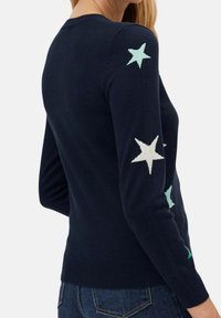 Navy sweater with long sleeves, featuring light blue and white star patterns on the arms. Made from soft knit material, fitted design.
