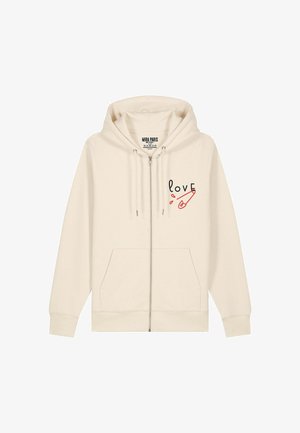Kremna zip-up jopica iz mehkega materiala. Ima sprednje žepke in na levi strani prsnega dela ima napis "love" z grafiko rdeče varnostne sponke.