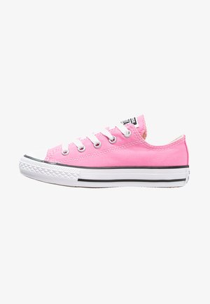 Pink canvas low-top sneakers with white laces, rubber toe cap, and black accent stripes on the midsole. Textured sole for grip.