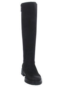 Stivali alti neri in suede con punta tondeggiante e suola robusta in gomma nera. Presentano una cerniera laterale per una facile calzata. Trama liscia.