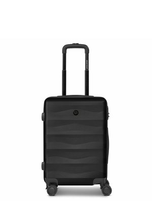 Black hard-shell suitcase with telescoping handle and four wheels, featuring subtle horizontal wave patterns on the surface.