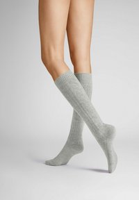 Graue kniehohe Socken aus strukturiertem Strickmaterial mit ribbeltem Bündchen und dezentem Muster entlang der Seiten.