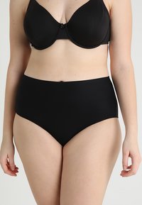 High-waisted black underwear made from smooth fabric, featuring a seamless design with a matte finish and no visible seams or patterns.