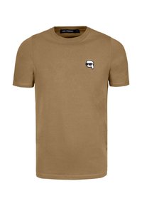 Camiseta de manga corta color caqui hecha de algodón con un pequeño gráfico en blanco y negro en el lado izquierdo del pecho. Textura suave y escote en forma de tripulación.