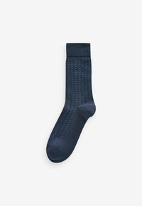 Navy blue socks with a textured pattern of lighter blue dots. Features a smooth finish and ribbed cuff. Standard sock shape.