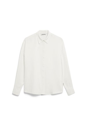White long-sleeve shirt with a collar, made from smooth fabric. Features a buttoned front and rounded hem, with a subtle logo tag on the side.