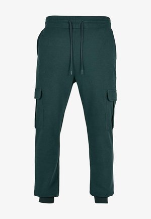 Ciemnozielone spodnie joggery cargo z elastyczną talią, sznurkiem do regulacji, bocznymi kieszeniami z patkami oraz ściągaczami przy kostkach.