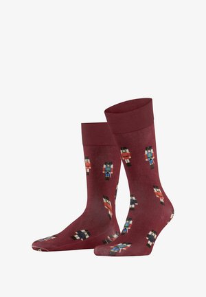 Burgundy socks featuring a nutcracker design in various colors, with a smooth texture and ribbed cuff for a secure fit.