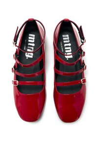 Zapatos de charol rojo con múltiples correas y hebillas, diseño de punta redondeada y una superficie suave y brillante. Fabricados en España.