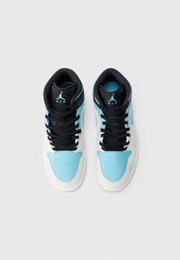 Par visoko obuvenih tenisica s crnim vezicama, svijetlo plavim kapicama, bijelim srednjim dijelovima i crnim jezicima sa plavim Jumpman logom.