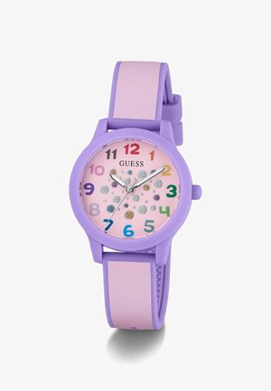 Fialové silikonové hodinky s pastelově růžovým ciferníkem. Obsahují barevné číslice, dekorativní tečky a stříbrné ručičky. Zajištěny fialovým páskem.
