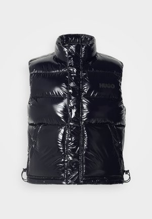 Black shiny puffer vest with high collar, front zip and snap pockets, featuring a subtle "HUGO" logo on the chest.