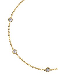 Auksinė grandinėlė su trimis tolygiai išdėstytomis apvaliomis skaidriomis kristalų akutėmis, įstatytomis į apskritus rėmelius. Lygūs grandinėlės žiedai sukuria subtilų tekstūros pojūtį.