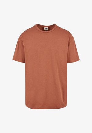 T-shirt in cotone color ruggine con scollo rotondo e maniche corte. Tessuto morbido, vestibilità rilassata e orlo inferiore dritto.