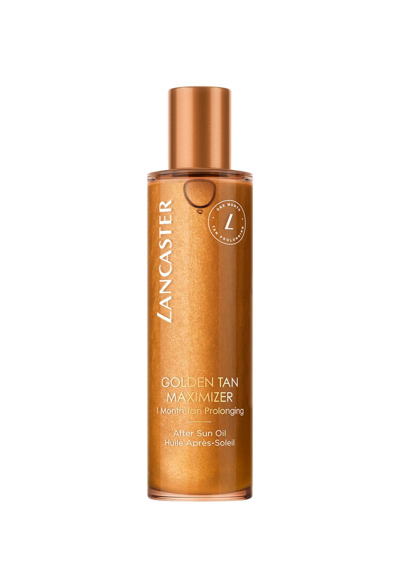 Gouden tan olie in een doorzichtige fles. Kenmerkt zich door een metallic gouden dop, een zachte textuur en gouden glitters. Etiket bevat productdetails in het wit.