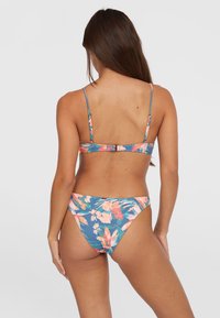 Floral bikini set featuring a blue background with pink and orange flowers, thin straps, and a clasp closure at the back. Smooth texture.