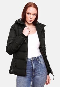 Black puffer jacket with a hood, zippered front, and quilted design. Features faux fur accents on the hood and ribbed cuffs. Paired with blue jeans.